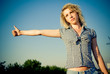 Beautiful country girl hitchhiking on the road Beautiful country girl hitchhiking on the road