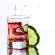red cocktail with lime on white