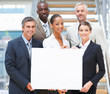 Business group holding a blank board on the stairs