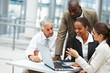 Team of business people working on a laptop
