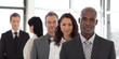 Five person Business team looking at camera and smiling