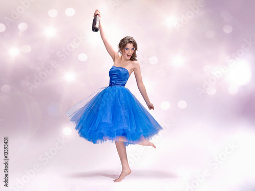 Photo: Beautiful woman in blue dress with champagne Beautiful woman in blue dress with champagne