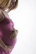 Image of pregnant woman touching her belly with hands..