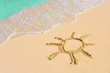 Drawing sun on beach
