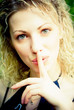 Shh. secret - Young beautiful woman with her finger over her mou Shh. secret - Young beautiful woman with her finger over her mou