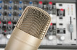 Studio microphone on the audio control console background