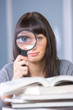 Young student studying with a magnifying glass
