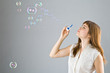 Young beautiful girl blow out soap bubbles Young beautiful girl blow out soap bubbles