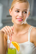 Young attractive happy woman with glass of juice or cocktail