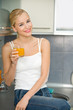 Young beautiful woman with glass of juice, indoors