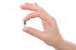 Hand holding a capsule or pill isolated on white. Hand holding a capsule or pill isolated on white.
