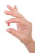 Hand holding a capsule or pill isolated on white.. Hand holding a capsule or pill isolated on white..
