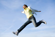 Happy young man - jumping end flies in blue sky Happy young man - jumping end flies in blue sky