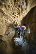 Climber clinging to a cliff.