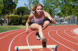 Athletic girl hurdling at the track Athletic girl hurdling at the track