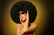 Beautiful woman with huge afro haircut on yellow