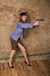 The girl-militiaman fulfils receptions of shooting from a pistol