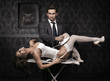 Handsome man ironing attractive brunette