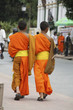 Two boy monks walking on the street in Laos