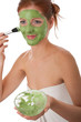 Body care series - Attractive woman applying green facial mask