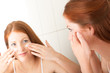 Body care series - Attractive young woman applying cream
