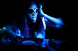cool afro american DJ in action under blue light
