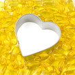 silver outlined white heart surrounded by salmon oil