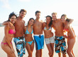 Group of friends standing at the sea shore