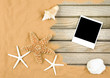 sand and wood background with polaroid frame