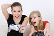 happy teenage girls playing playstation