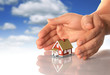 Photo : Hands and little house.