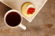Tea with a butter cookie smothered with cream cheese and jam Tea with a butter cookie smothered with cream cheese and jam