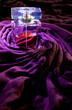 Violet bottle of perfume on cloth Violet bottle of perfume on cloth