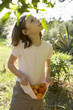 Young girl outside collecting fruit Young girl outside collecting fruit