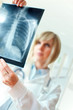 Female doctor examing an x-ray Female doctor examing an x-ray