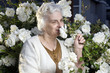 Happy senior lady in the rose garden Happy senior lady in the rose garden