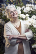 Happy senior lady in the rose garden looking up Happy senior lady in the rose garden looking up