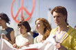 Four young people holding banner at peace demonstration in Munich, Bavaria, Germany