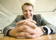 Photo: Close-up of clasped hands of mature man sitting at table Close-up of clasped hands of mature man sitting at table