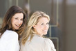 Photo: Portrait of two women looking over their shoulders, Stuttgart, Baden-Wurttemberg, Germany Portrait of two women looking over their shoulders, Stuttgart, Baden-Wurttemberg, Germany