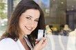 Photo: Portrait of young woman holding a credit card, Stuttgart, Baden-Wurttemberg, Germany Portrait of young woman holding a credit card, Stuttgart, Baden-Wurttemberg, Germany