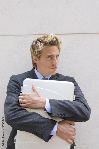 Photo: Businessman holding files to his chest, Stuttgart, Baden-Wurttemberg, Germany Businessman holding files to his chest, Stuttgart, Baden-Wurttemberg, Germany