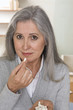 Mature woman taking pills