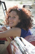 Young woman getting out of car, smiling, close-up, Havana, Cuba