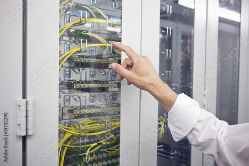 Photo: Detail of computer server with hand pointing to it Detail of computer server with hand pointing to it