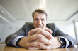 Photo: Close-up of clasped hands of mature man sitting at table in Munich, Bavaria, Germany Close-up of clasped hands of mature man sitting at table in Munich, Bavaria, Germany