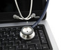 Stéthoscope posé sur un clavier de portable Stéthoscope posé sur un clavier de portable