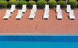 Chaise longues by swimming-pool