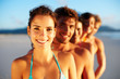 Happy woman with friends at the back on the sea shore