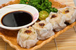 Dimsum (siomai) with soy sauce on the side Dimsum (siomai) with soy sauce on the side